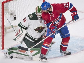 Minnesota Wild's goalie Devan Dubnyk stops Montreal Canadiens' Mike Brown (13) during third period NHL hockey action in Montreal on Saturday, March 12, 2016.