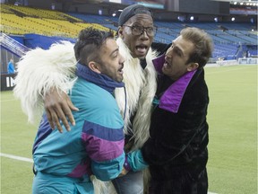 Montreal Impact striker Didier Drogba jokes around with Italian comedians Pio, left, and Amedeo, right, after a press conference, Thursday, March 3, 2016 in Montreal. Drogba will miss four of the first five games of the season to avoid playing on artificial turf.