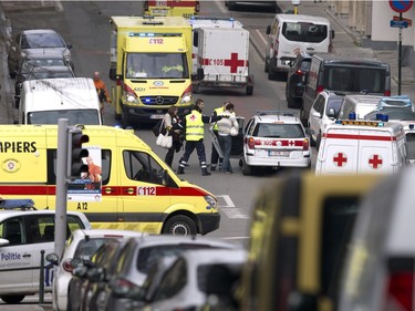 Emergency services evacuate a woman after a explosion in a main metro station in Brussels on Tuesday, March 22, 2016. Explosions rocked the Brussels airport and the subway system Tuesday, killing at least 13 people and injuring many others just days after the main suspect in the November Paris attacks was arrested in the city, police said.
