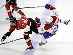 Ottawa Senators' Erik Karlsson collides with Montreal Canadiens' Stefan Matteau at the blue line during second period NHL hockey action in Ottawa on Saturday, March 19, 2016.