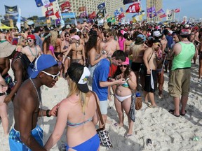 Partygoers fill the sand during spring break in Panama City Beach, Fla.