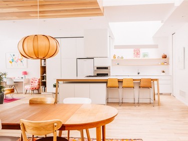 Flooring is white oak finished with a white oil, and the white kitchen, with stainless steel appliances, has white oak accents. Photo by Vivian Doan