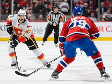 Michael Frolik of the Calgary Flames carries the puck as Andrei Markov of the Montreal Canadiens defends at the Bell Centre on March 20, 2016, in Montreal.