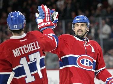Tomas Plekanec celebrates his first-period goal against the Anaheim Ducks with teammate Torrey Mitchell in Montreal Tuesday, March 22, 2016.