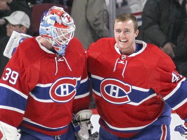 Goalie Mike Condon, left, gets a pat on the back from his backup, Ben Scrivens, following victory over the Anaheim Ducks in Montreal Tuesday March 22, 2016. (John Mahoney / MONTREAL GAZETTE)