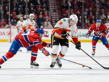 Max Pacioretty of the Montreal Canadiens challenges Michael Ferland of the Calgary Flames at the Bell Centre on March 20, 2016.