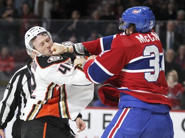 Michael McCarron hits Anaheim Ducks' Josh Manson with a right hand during first- period fight in Montreal Tuesday March 22, 2016.