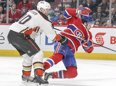 Alex Galchenyuk is knocked off his skates by Anaheim Ducks' Corey Perry during third-period action in Montreal Tuesday, March 22, 2016.
