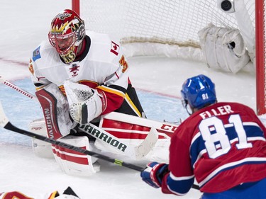 Calgary Flames goalie Niklas Backstrom makes a save off Montreal Canadiens' Lars Eller during second-period -action Sunday, March 20, 2016, in Montreal.