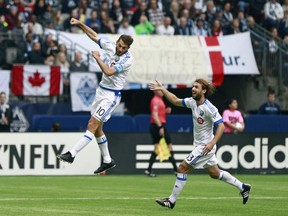 Marco Donadel celebrates with teammate Ignacio Piatti of the Montreal Impact after scoring against the Vancouver Whitecaps during their MLS game March 6, 2016, at BC Place in Vancouver.