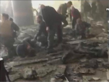 In this still image taken from video from RTL Belgium  people receive treatment in the debris strewn terminal at Brussels Airport, in Brussels after explosions Tuesday, March 22, 2016. Authorities locked down the Belgian capital on Tuesday after explosions rocked the Brussels airport and subway system, killing  a number of people and injuring many more. Belgium raised its terror alert to its highest level, diverting arriving planes and trains and ordering people to stay where they were. Airports across Europe tightened security.  (RTL via AP) BELGIUM OUT TV OUT NO ARCHIVE
