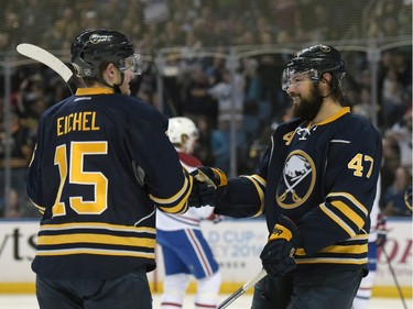 Buffalo Sabres' Jack Eichel (15) celebrates with Zach Bogosian (47) after Bogosian scored during the first period of an NHL hockey game against the Montreal Canadiens, Wednesday, March 16, 2016, in Buffalo, N.Y.