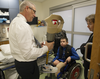 Carlo Berretta, v.p. of J.E. Hanger orthotics-prosthetics holds a prosthetic leg while talking with physiotherapist Rochelle Rein as 11-year-old Mykola Nyzhnykovskyi  watches at Shriners Hospitals for Children in Montreal Tuesday, March 15, 2016. Mykola lost his legs and an arm in East Ukraine and sustained other serious injuries from an exploding grenade that killed his younger brother.