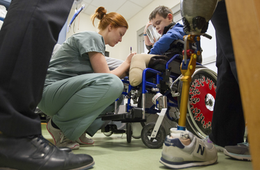 Nurse orthopedic technician Stéphanie Thierry makes some marks on a scarline of an amuputated leg of 11-year-old Mykola Nyzhnykovskyi at Shriners Hospitals for Children in Montreal Tuesday, March 15, 2016. Mykola lost his legs and an arm in East Ukraine and sustained other serious injuries from an exploding grenade that killed his younger brother.