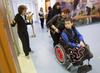 Alla Nyzhnykovska wheels her son, 11-year-old Mykola Nyzhnykovskyi, towards a session where he would be working on his prosthetic legs with physiotherapist Rochelle Rein (left) at Shriners Hospitals for Children in Montreal Tuesday, March 15, 2016. Mykola lost his legs and an arm in East Ukraine and sustained other serious injuries from an exploding grenade that killed his younger brother.