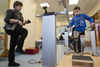 Mykola Nyzhnykovskyi takes part in a session on his prosthetic legs at Shriners Hospitals for Children in Montreal Tuesday, March 15, 2016 as his mother Alla Nyzhnykovska encourages him. Mykola lost his legs and an arm in East Ukraine and sustained other serious injuries from an exploding grenade that killed his younger brother.