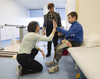 hysiotherapist Rochelle Rein and Mykola Nyzhnykovskyi 'high-five' as Mykola's mother Alla Nyzhnykovska looks on at Shriners Hospitals for Children in Montreal Tuesday, March 15, 2016. Mykola lost his legs and an arm in East Ukraine and sustained other serious injuries from an exploding grenade that killed his younger brother.