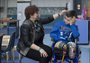 Alla Nyzhnykovska fixes the hair of her son Mykola Nyzhnykovskyi after a session on his prosthetic legs at Shriners Hospitals for Children in Montreal Tuesday, March 15, 2016. Mykola lost his legs and an arm in East Ukraine and sustained other serious injuries from an exploding grenade that killed his younger brother.