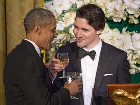 Prime Minister Justin Trudeau proposes a toast to U.S. President Barack Obama during a state dinner Thursday, March 10, 2016 in Washington. Canada is still ahead of the U.S. on the happiness scale a report released Wednesday says.