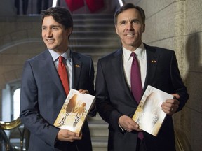 Prime Minister Justin Trudeau, left, poses with Minister of Finance Bill Morneau as he arrives to table the budget on Parliament Hill, Tuesday, March 22, 2016 in Ottawa.