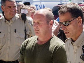 Thomas Harding, centre, conductor for the train that derailed and exploded in Lac-Mégantic on July 6, 2013 killing 47 people, arrives at a courthouse in Lac-Mégantic, 270 kilometres east of Montreal on Tuesday, May 13, 2014.