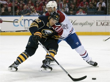 Buffalo Sabres left winger Marcus Foligno (82) skates by the check of Montreal Canadiens defenseman Victor Bartley (20) during the first period of an NHL hockey game, Wednesday, March 16, 2016, in Buffalo, N.Y.