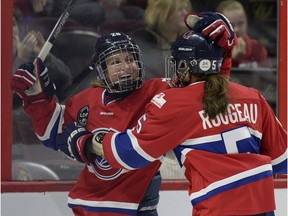 Les Canadiennes' Marie-Philip Poulin, left, celebrates with teammate Lauriane Rougeau at the Canadian Women's Hockey League final action at the Clarkson Cup on Sunday March 13, 2016, in Ottawa.