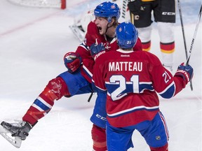Montreal Canadiens' Michael McCarron, left, celebrates his first NHL goal scored against Calgary Flames goalie Niklas Backstrom with teammate Stefan Matteau during third period NHL hockey action Sunday, March 20, 2016 in Montreal. The Canadiens went on to lose 4-1 against the Flames.