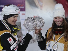Quebecers Mikaël Kingsbury, left, and Chloé Dufour-Lapointe display their Crystal Globe trophies after the World Cup freestyle skiing final city event in Moscow, Russia, on Saturday, March 5, 2016. It's the first time Canada has claimed both men's and women's trophies.