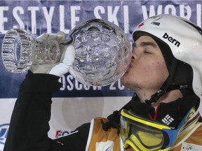 Canada's Mikael Kingsbury kisses the Crystal Globe trophy after winning the men's dual moguls at the World Cup freestyle skiing final city event in Moscow, Russia, on Saturday, March 5, 2016. Kingsbury captured his fifth consecutive Crystal Globe for the overall World Cup moguls title.