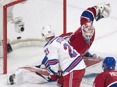 Montreal Canadiens goaltender Mike Condon is scored on by New York Rangers' Derek Stepan during second period NHL hockey action in Montreal, Saturday, March 26, 2016.