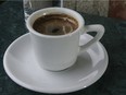 Traditional Greek coffee in a small cup.