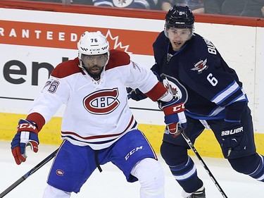 Montreal Canadiens defenceman P.K. Subban (left) spins off a check from Winnipeg Jets centre Alex Burmistrov in Winnipeg on Sat., March 5, 2016.