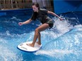 Charlotte Sarrazin rides the artificial waves at Oasis Surf on Friday March 25, 2016, in Brossard.