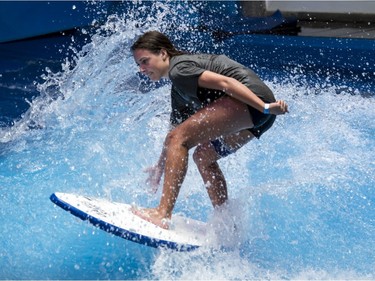Charlotte Sarrazin rides the artificial waves at Oasis Surf on Friday March 25, 2016, in Brossard.