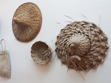 A hallway wall features woven hats, baskets and a bag. (John Mahoney / MONTREAL GAZETTE)