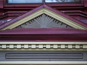 Maintain it or lose it: Decorative woodwork above a bay window on a house with Second Empire style, inspired by French architecture.