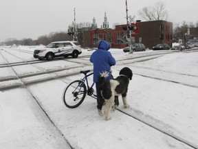 A train crossing on de Courcelle St. south of St-Jacques St. in Montreal Thursday, January 14, 2016 where trains, freight and passenger, cars and pedestrians cross over the road. Daniel Green says this is a potential trouble spot.