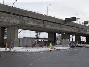 A flagman stands on St. Remi street as traffic flows underneath the Ville-Marie Expressway in Montreal on Thursday January 7, 2016.