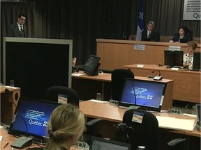 An unidentified engineer from the firm Roche testifies behind a screen to protect his identity at the Charbonneau Commission Thursday June 12, 2014 in Montreal.