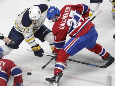 Alex Galchenyuk of the Montreal Canadiens and Johan Larsson of the Buffalo Sabres battle for the puck during a face-off in the first period of an NHL game at the Bell Centre in Montreal Thursday, March 10, 2016.