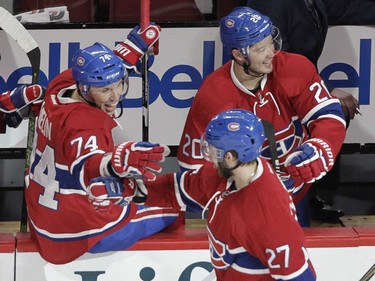 Alex Galchenyuk of the Montreal Canadiens celebrates his second goal of the game against the Buffalo Sabres with teammates Alexei Emelin (left) and Victor Bartley in the second period of an NHL game at the Bell Centre in Montreal Thursday, March 10, 2016.