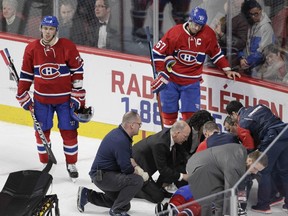Canadiens captain Max Pacioretty and defenceman Alexei Emelin look on as teammate P.K. Subban is tended to by the team's medical staff after sustaining a neck injury during win over the Buffalo Sabres at the Bell Centre on March 10, 2016.