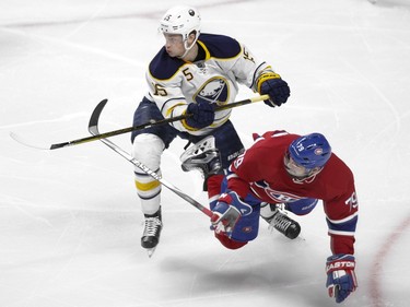 Andrei Markov of the Montreal Canadiens is knocked down by Jack Eichel of the Buffalo Sabres in the first period of an NHL game at the Bell Centre in Montreal Thursday, March 10, 2016.