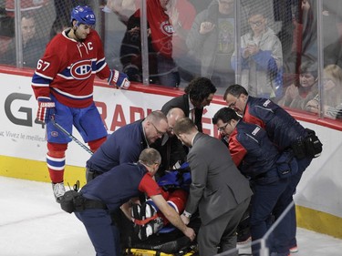 Captain Max Pacioretty of the Montreal Canadiens looks downward as teammate P.K. Subban is put on a stretcher by the team's medical staff after sustaining an injury against the Buffalo Sabres in the third period of an NHL game at the Bell Centre in Montreal Thursday, March 10, 2016.