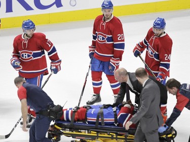 P.K. Subban of the  Montreal Canadiens is taken off the ice on a stretcher after sustaining an injury against the Buffalo Sabres in the third period of an NHL game at the Bell Centre in Montreal Thursday, March 10, 2016 as teammates, from the left: Torrey Mitchell, Victor Bartley and Phillip Danault watch.