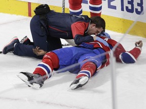 P.K. Subban of the Montreal Canadiens is tended to by a member of the team's training staff after sustaining an injury against the Buffalo Sabres in the third period of an NHL game at the Bell Centre in Montreal Thursday, March 10, 2016.