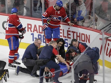 P.K. Subban of the Montreal Canadiens is tended to by the team' medical staff after sustaining an injury against the Buffalo Sabres in the third period of an NHL game at the Bell Centre in Montreal Thursday, March 10, 2016. Standing by are captain Max Pacioretty (right) and Alexei Emelin.