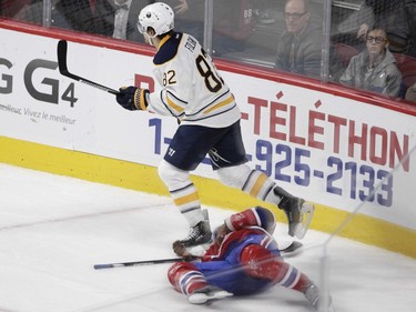 P.K. Subban of the Montreal Canadiens lays writhing on the ice after sustaining an injury against the Buffalo Sabres in the third period of an NHL game at the Bell Centre in Montreal Thursday, March 10, 2016. Skating past him is Marcus Foligno.