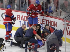 Canadiens' P.K. Subban is tended to by medical staff after sustaining an injury against the Buffalo Sabres at the Bell Centre in Montreal on Thursday, March 10, 2016. Standing by are captain Max Pacioretty (right) and Alexei Emelin.